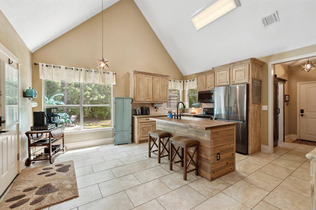 The chef in your family will love this kitchen! Plenty of cabinet and counter space, Butcher block Island with single basin Farm house sink, black Stainless steel appliances, pantry, and appliance shelving in the adjoining laundry room.
