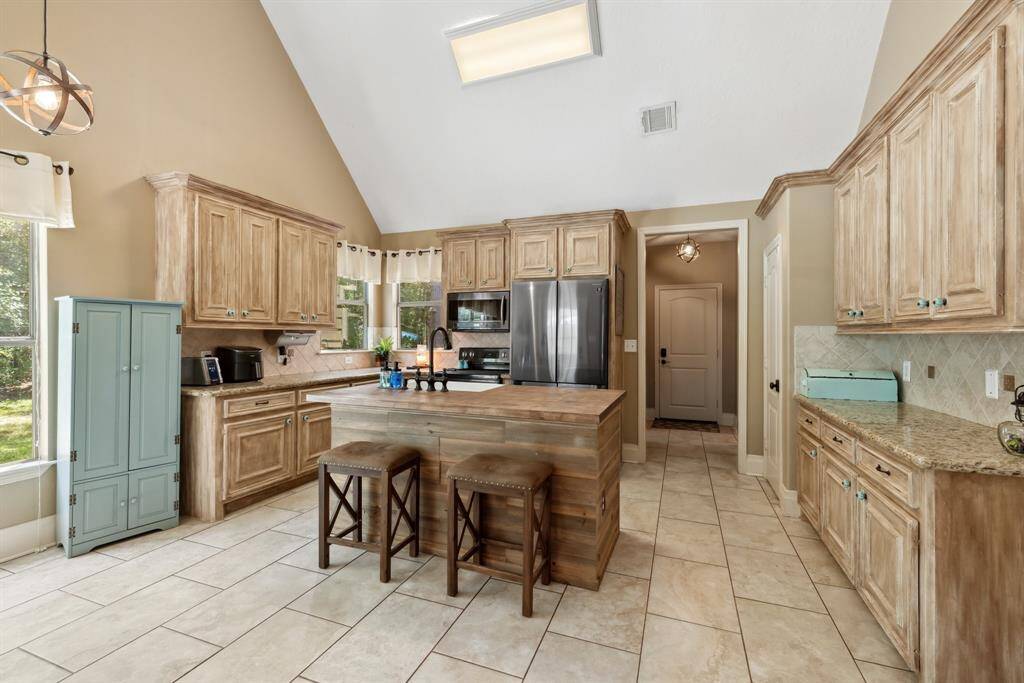 The island bar will become the favorite space in this kitchen for the taste-testers in your family!  Notice the custom painted finish on the cabinetry which adds to the charm of this space.