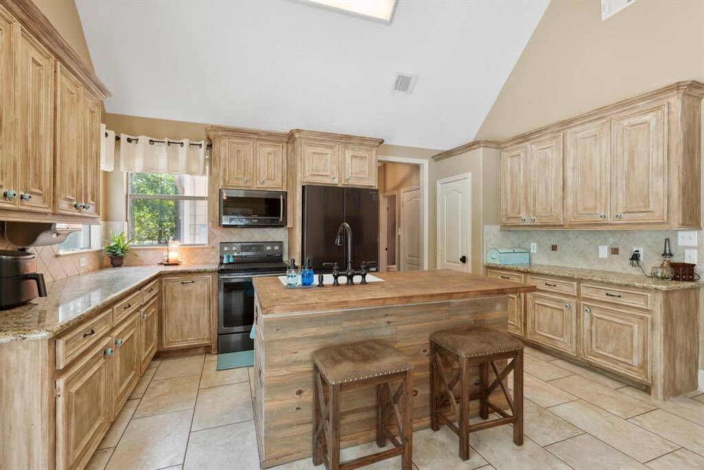 View from the kitchen sink looking towards the family room.  You'll never miss another minute of the big game or a single scene on  family movie night.  The exterior door leads to the backyard pool and entertaining space.