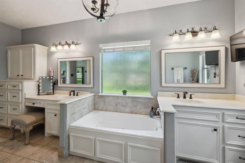 The home's second full bath is just down the hall and includes an oversized vanity, private tub/shower and commode area.  There is a private access from the home's 3rd bedroom into this full bath.