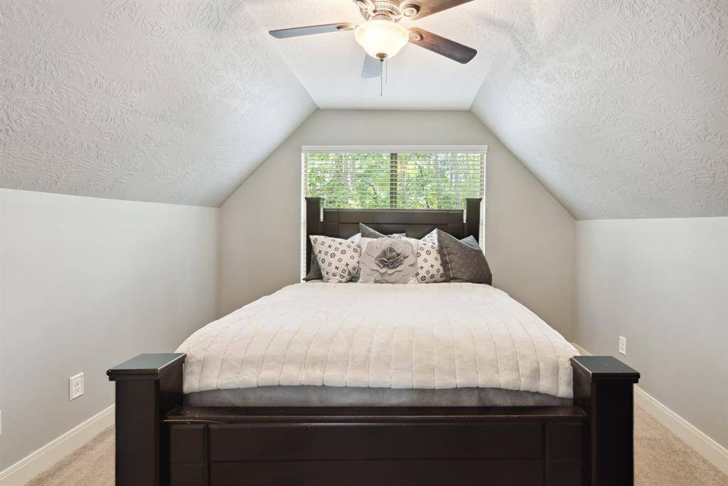 The downstairs guest bath is just off the kitchen and across from the laundry space.