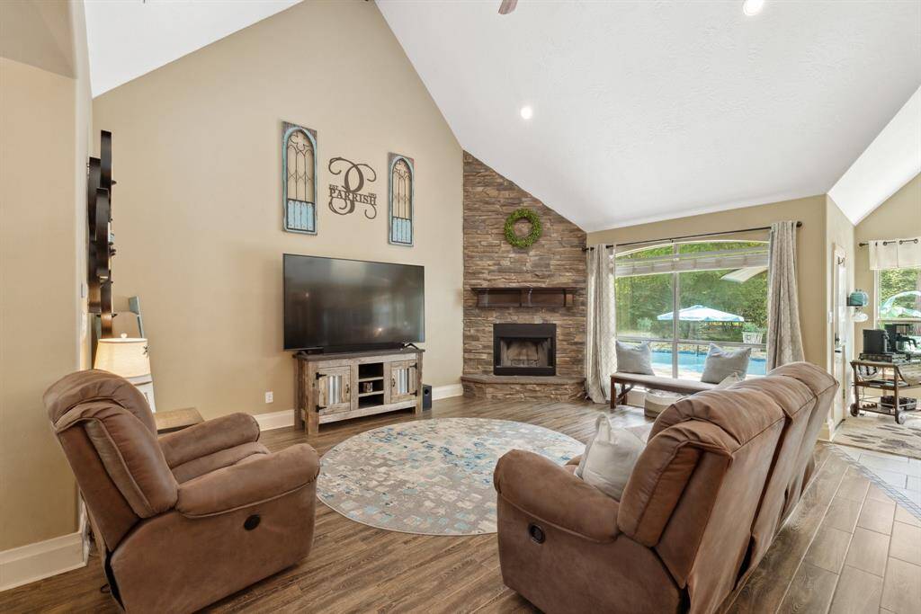 View from the front door looking into the large family room and beyond to the sparkling pool in the backyard. The vaulted ceiling stretches to 16' and gives a grand feel to the space.