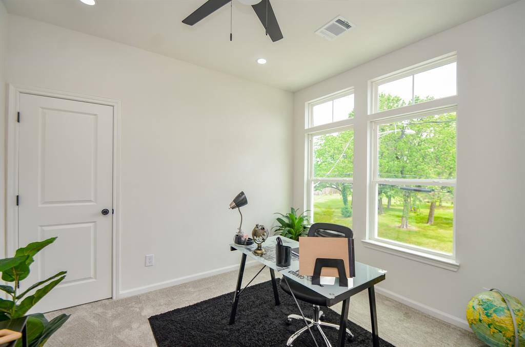Front secondary bedroom staged as a home office.  Door is to full bathroom Jack and Jill bathroom.