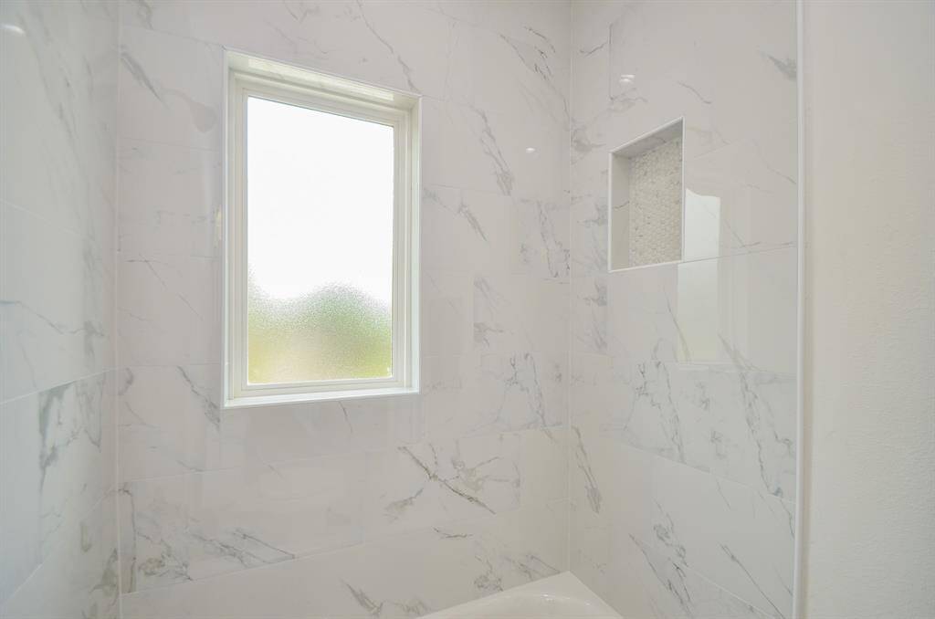 Notice the shower niche with the mosaic tile detail.