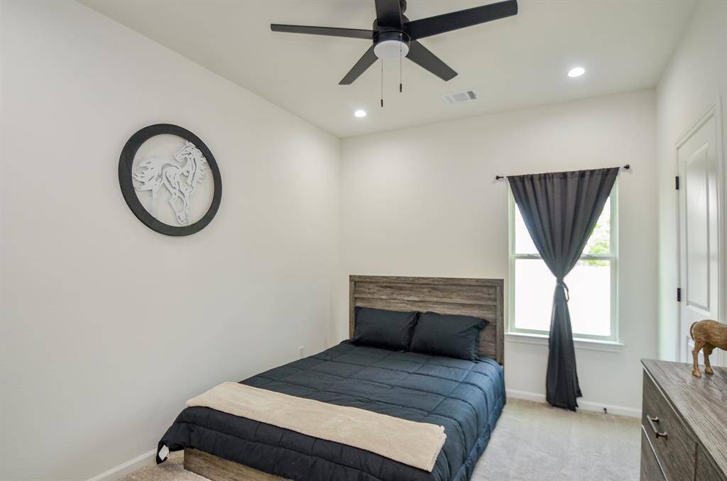Middle room features a clean, modern design with light walls and carpet.