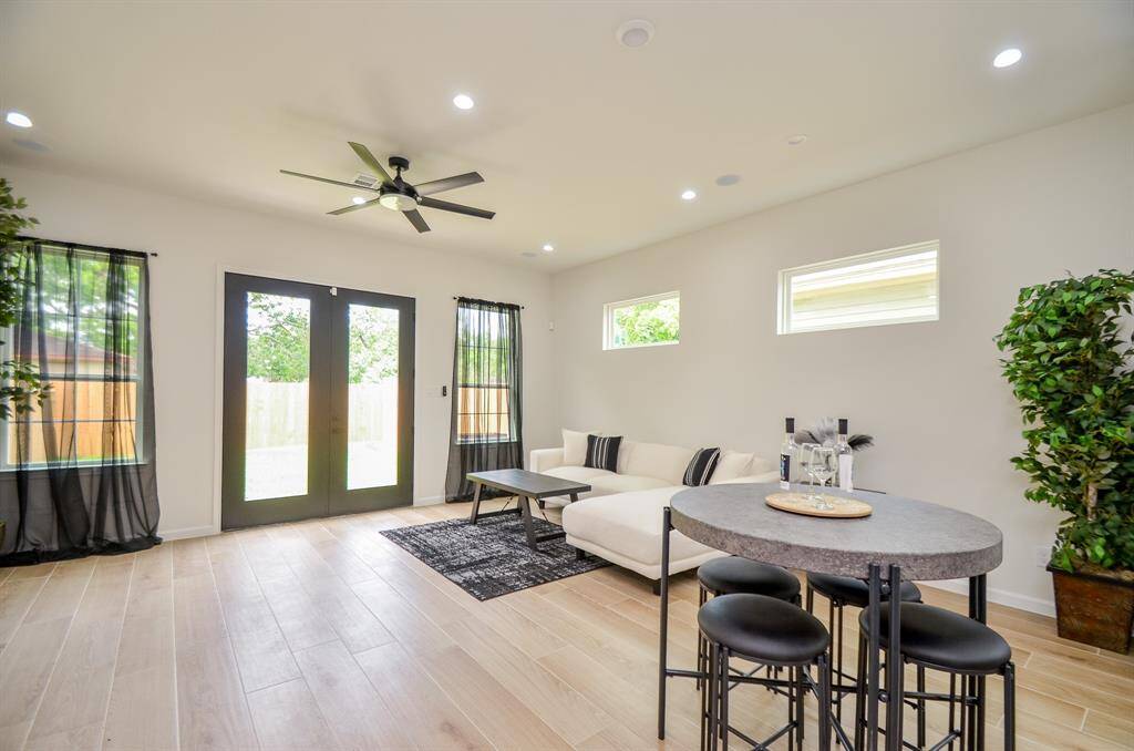 Elegant french doors open to a lush, fully sodded backyard.