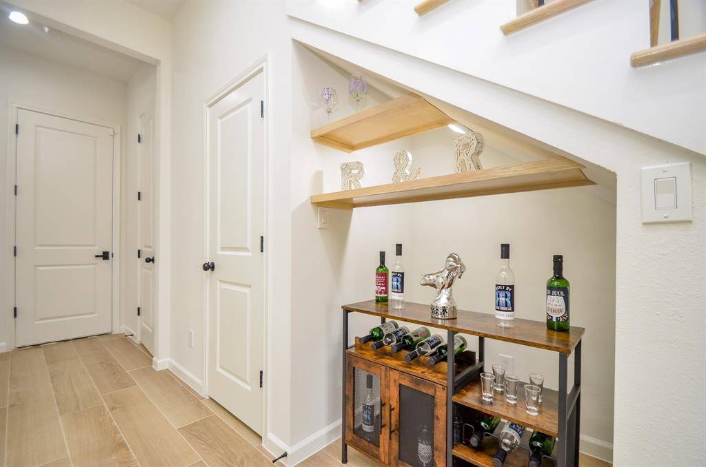 This beverage Niche is conveniently located under the staircase.  Door to the left is kitchen pantry.