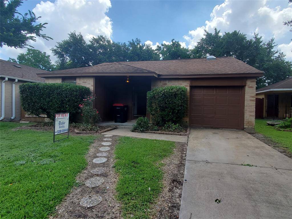 Front view of the two bedroom one bath property with freshly trimmed hedges and brand new tile in both bedrooms.