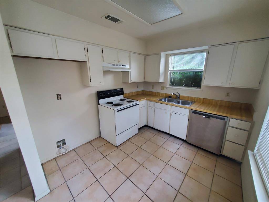 Well lit kitchen with built in cabinets.
