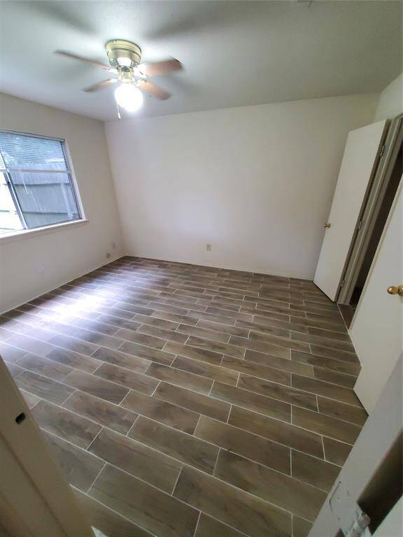 New tile in the primary bedroom, it has a ceiling fan and spacious closet!