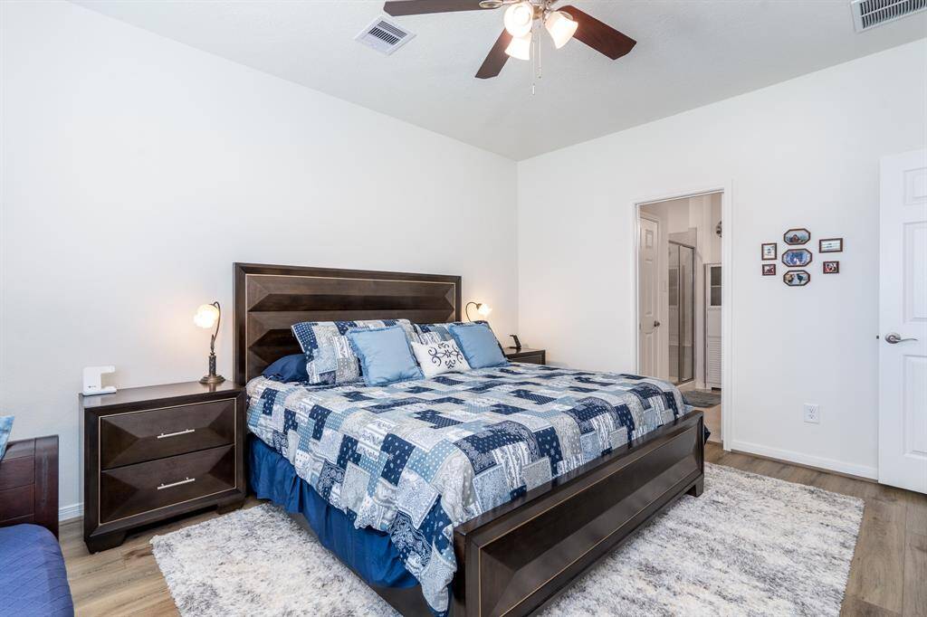 Primary bedroom with vinyl plank throughout the home