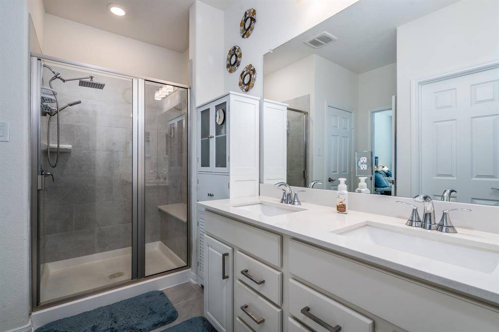 Primary bathroom with large standing shower with a shower bench