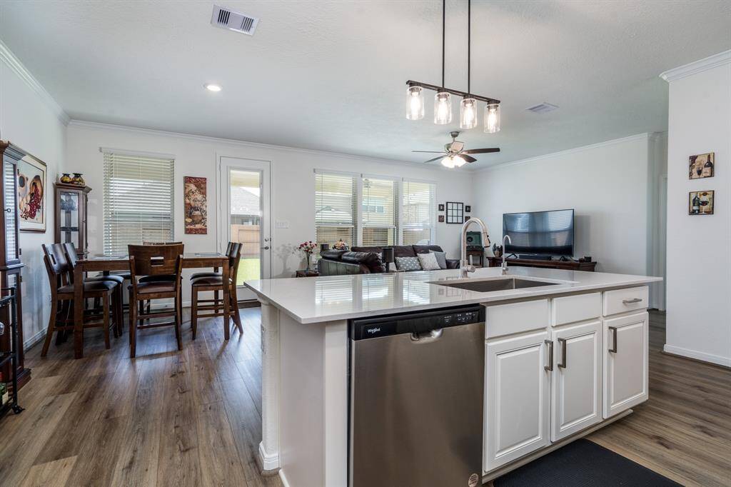 Gourmet kitchen with quartz countertop, modern backsplash, and stainless steel appliances
