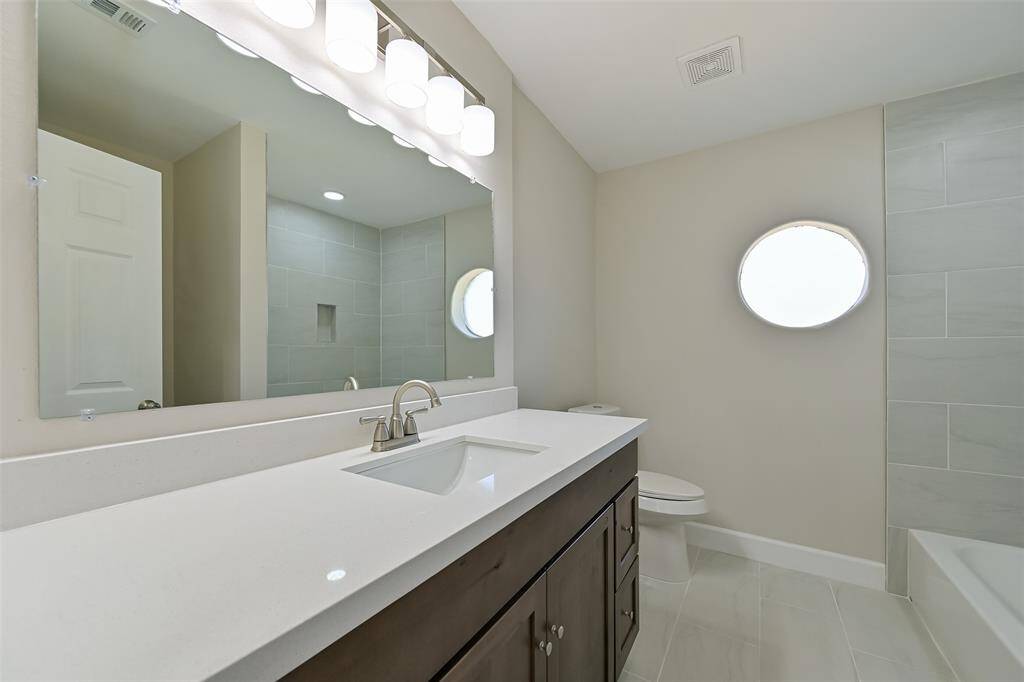 The two of the secondary bathrooms share a bathroom with a full tub and shower, plus additional storage