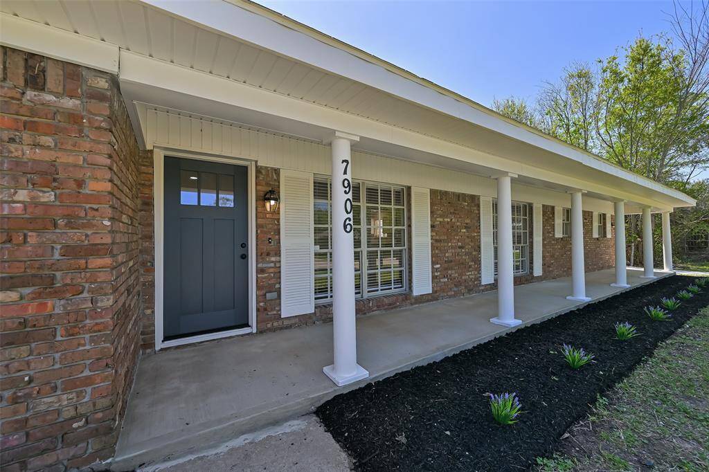 Welcome to 7906 Montglen- adorned with beautiful white columns, a sitting porch, and elegant front door.