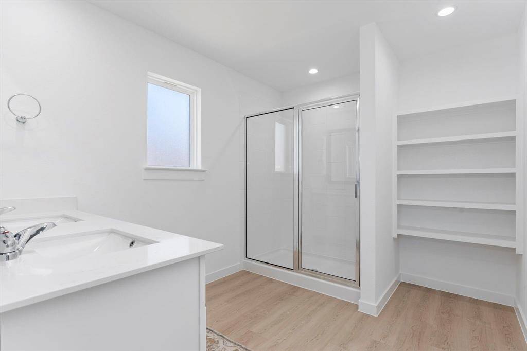 Primary bathroom with dual vanities and large walk in shower. All photos are representative of the home