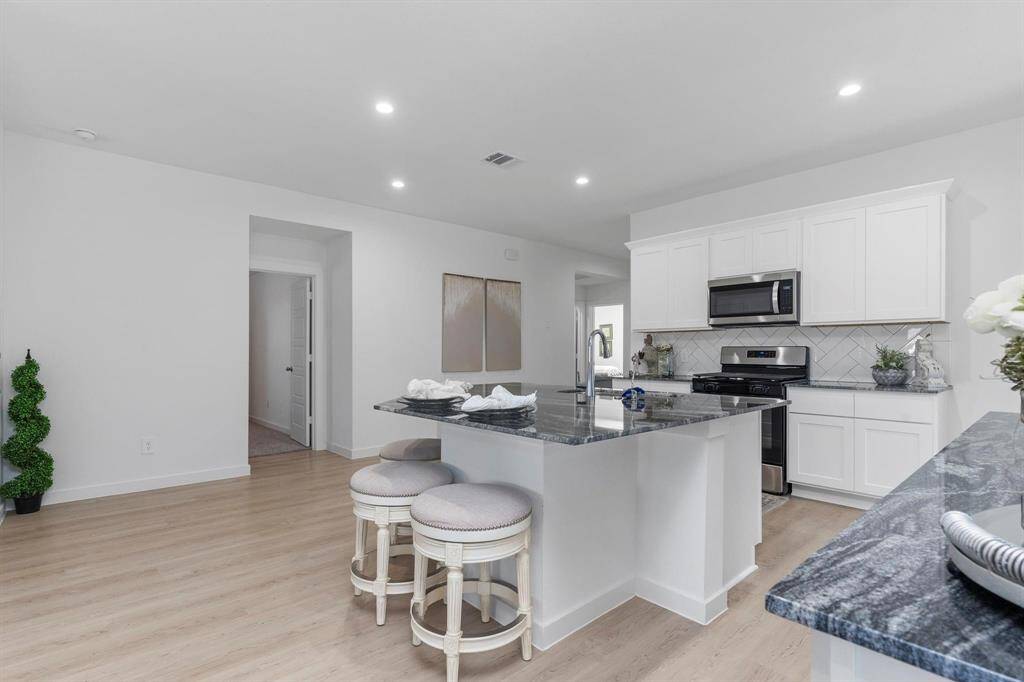 Huge island space in the kitchen. Kitchen area with modern touches and ample cabinet space. All photos are representative of the home