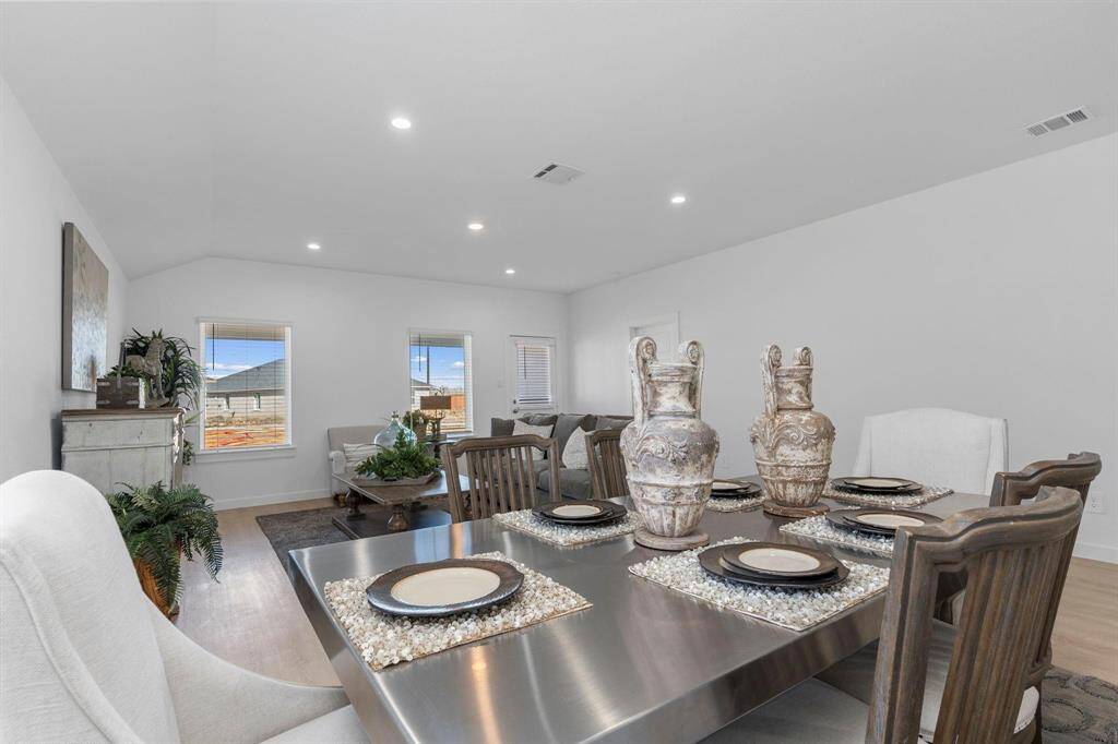 Dining area open to the living room. All photos are representative of the home