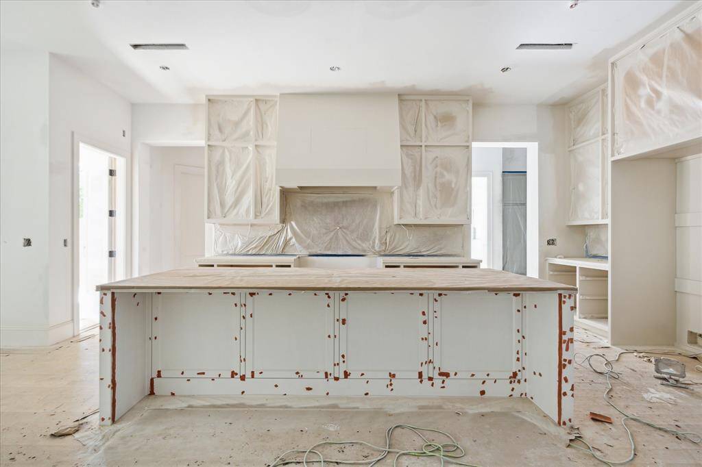 A recent progress picture of the Kitchen.  Thermador Appliances and plastered vent hood will complement this gorgeous space.