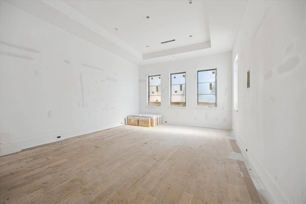 The Owner's Retreat is located on the first floor and features a coffered ceiling, seating area and windows overlooking the backyard.