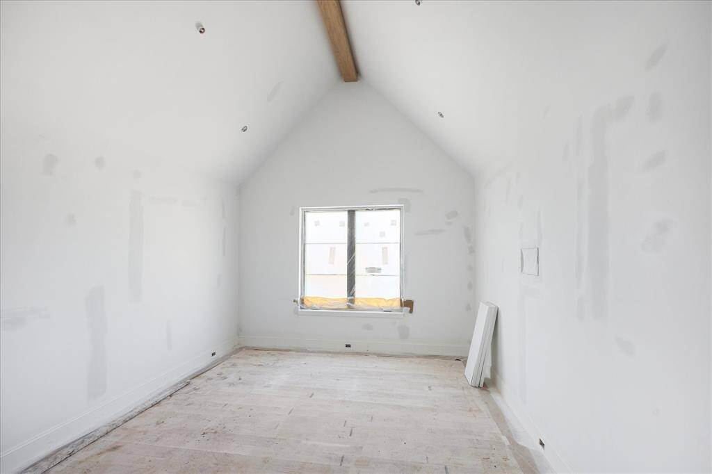 One of the secondary bedrooms upstairs. Three of the four bedrooms have cathedral ceilings with white oak beams. All bedrooms have in-wall TV boxes.