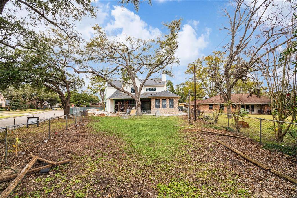 A view of the backyard and back elevation prior to putting the wood fence up.