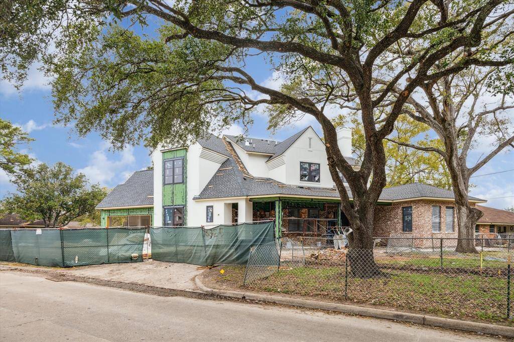 The gorgeous brick and stucco façade surround the house. This is a view of the side elevation and pavilion prior to the wooden fence.