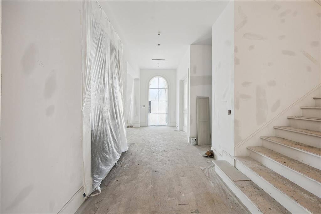 A view of the Foyer, Bar, and staircase. Progress Picture April 2025.