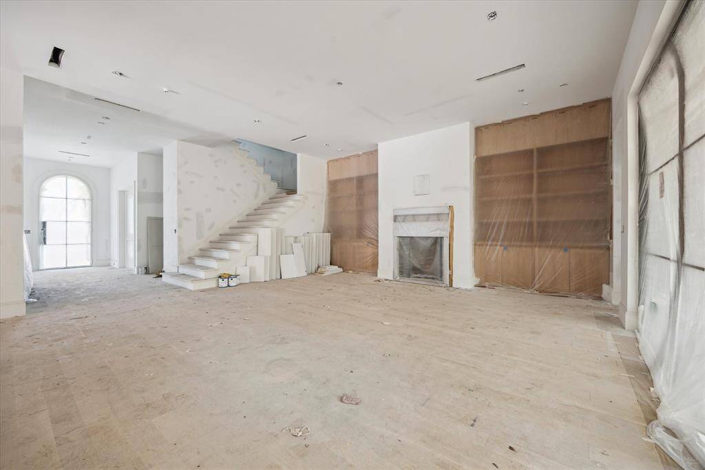 A recent picture of the Family Room with wood burning fireplace and stunning white oak built-ins.  A plastered mantel to be installed.