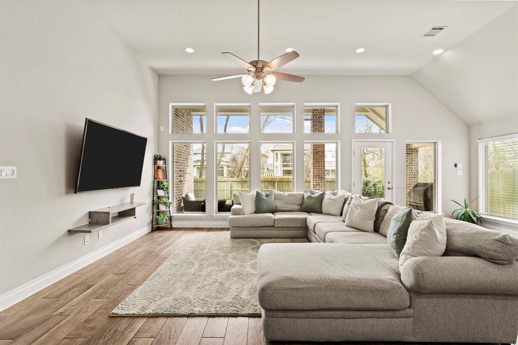 Another angle of the living room, showcasing the beautiful symmetry of the windows and entrance to the covered patio.