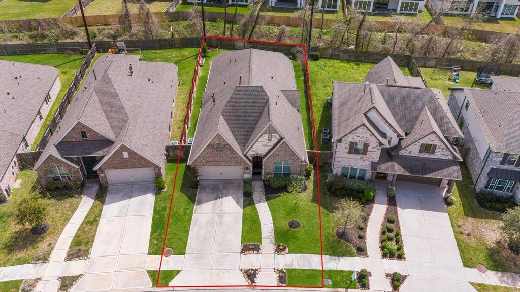 Elevated shot of the neighborhood, showing proximity to other houses and well-kept streets.