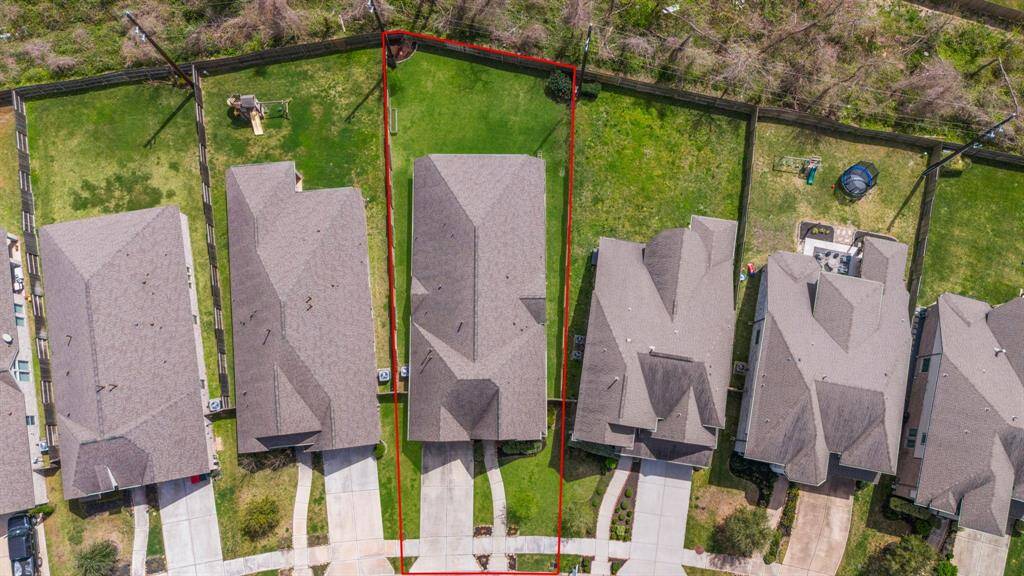 Direct overhead drone shot showing the entire roof, backyard, and layout of nearby homes.