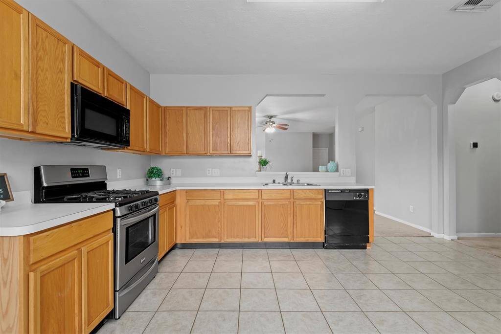 This kitchen has so much space for meal prep and dining! There is a gas range and plenty of cabinets and countertop space can be found here.