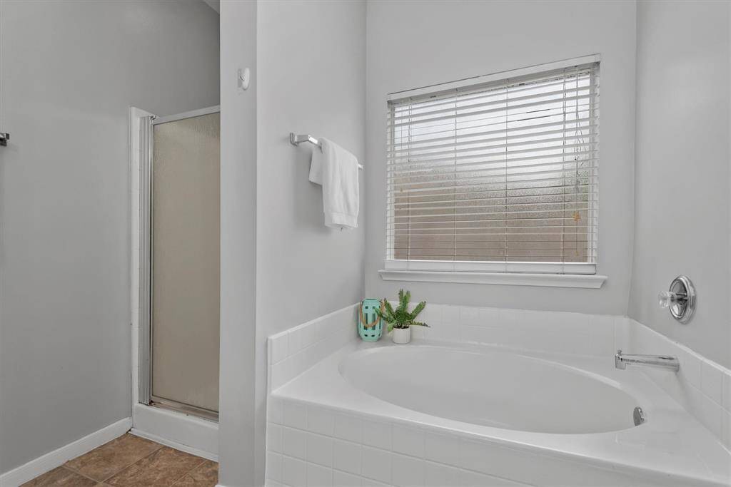 The primary bath suite has a separate shower and soaking tub.