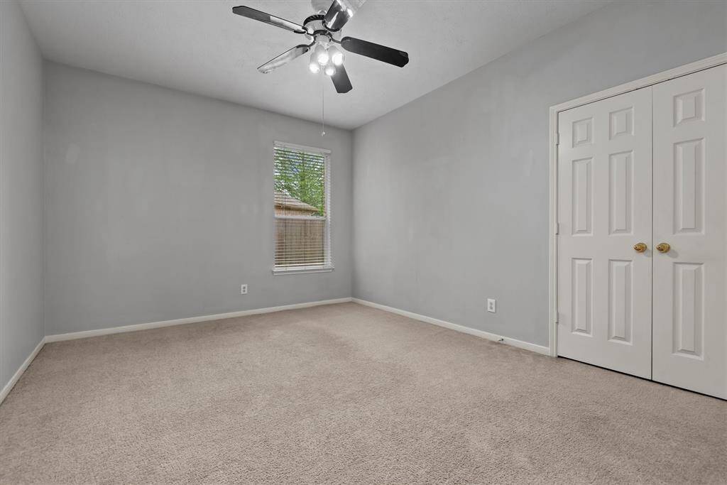 Moving back toward the front of the home, here is one of the secondary bedrooms with ample closet storage.