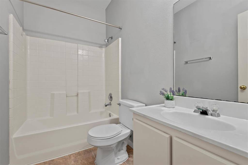 Full bathroom located conveniently near both secondary bedrooms.