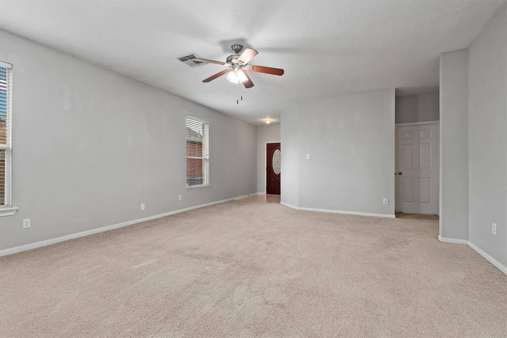 Down the hallway to the right are the two secondary bedrooms with a full bathroom along with garage entry. This is a true split floorplan which allows for plenty of privacy between the primary suite and secondary bedrooms.
