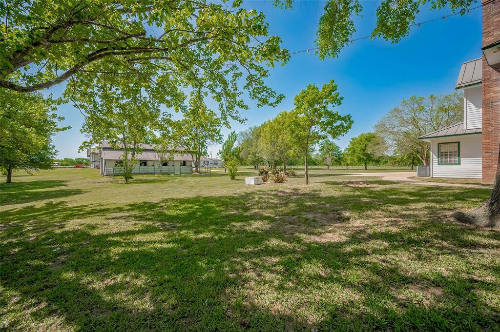 Back of home and view of horse barn
