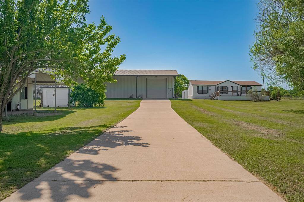 Concrete drive to horse stalls, huge workshop and guest home