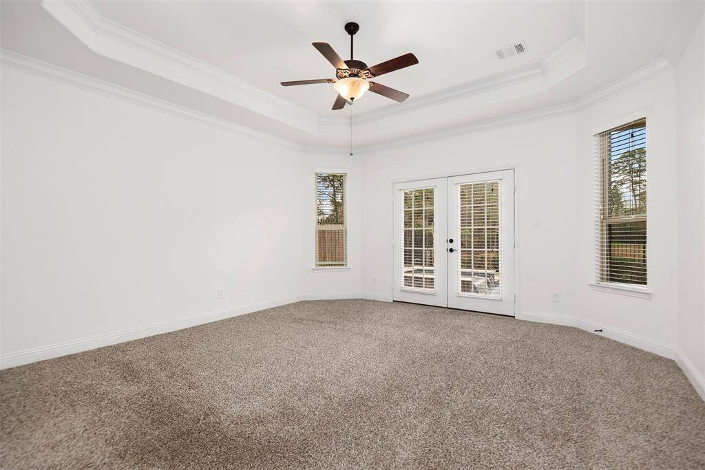 Huge primary bedroom with access to the backyard an pool area.
