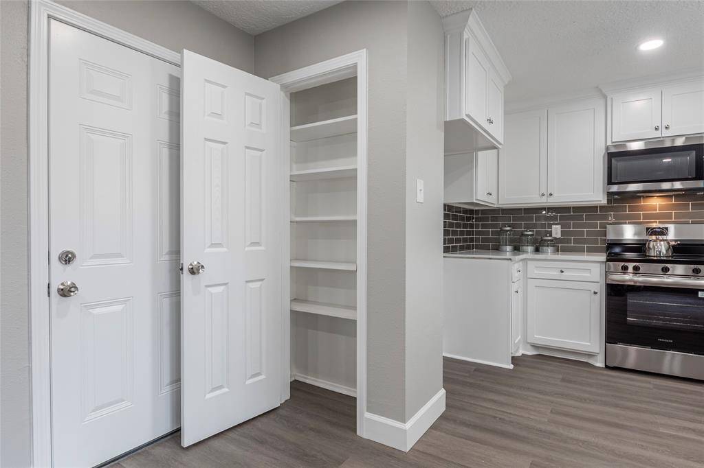 Kitchen area with pantry closet