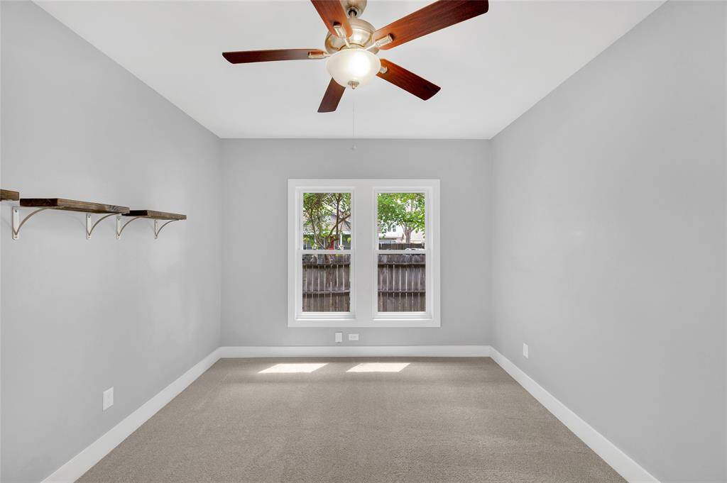 Second bedroom with a view of the side yard includes 2 closets.