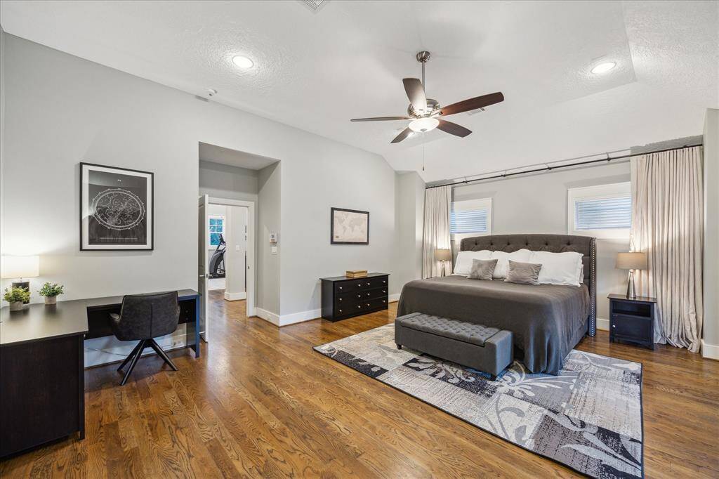 PRIMARY BEDROOM - Primary suite includes custom blackout curtains. Large space with room for a desk or seating area.