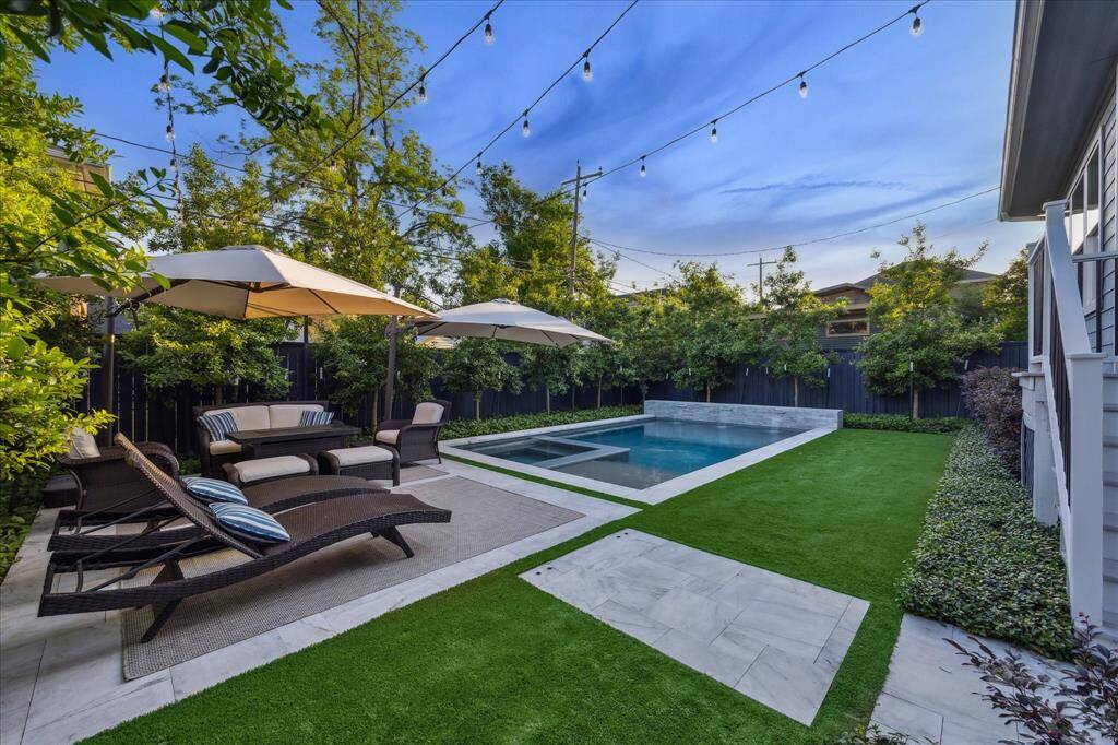 Backyard features an Italian marble patio, turf, professional landscaping and and stunning custom pool.