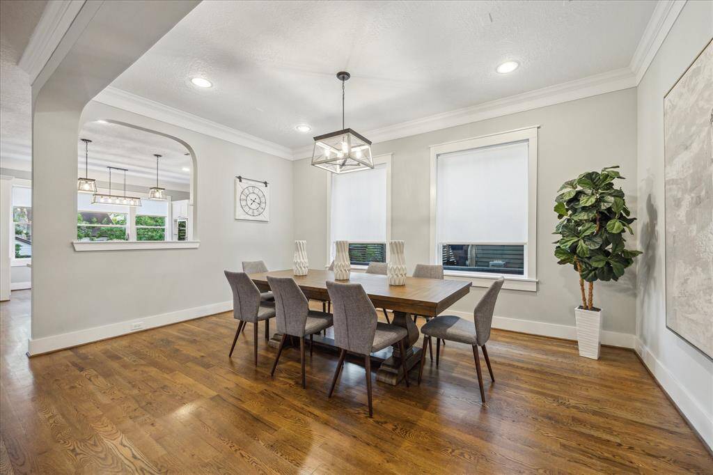 DINING ROOM II - Large formal dining room with wood floors, crown molding and custom light fixture.
