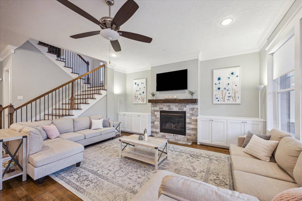LIVING ROOM II - Wood floors, crown molding and custom window treatments are carried throughout the home.