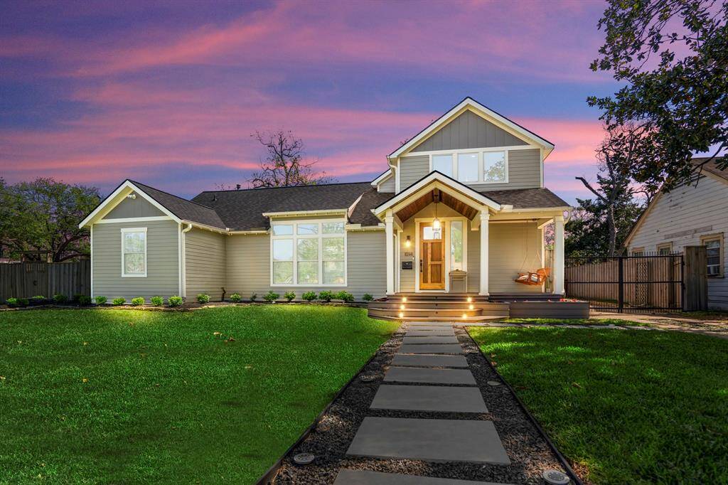 Modern landscaping and outdoor lighting add elegance after dark.