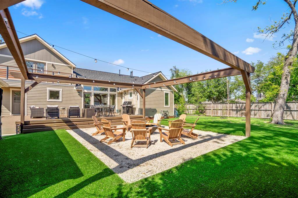 Outdoor living redefined—Trex decking, ambient lighting, and lush turf yard.