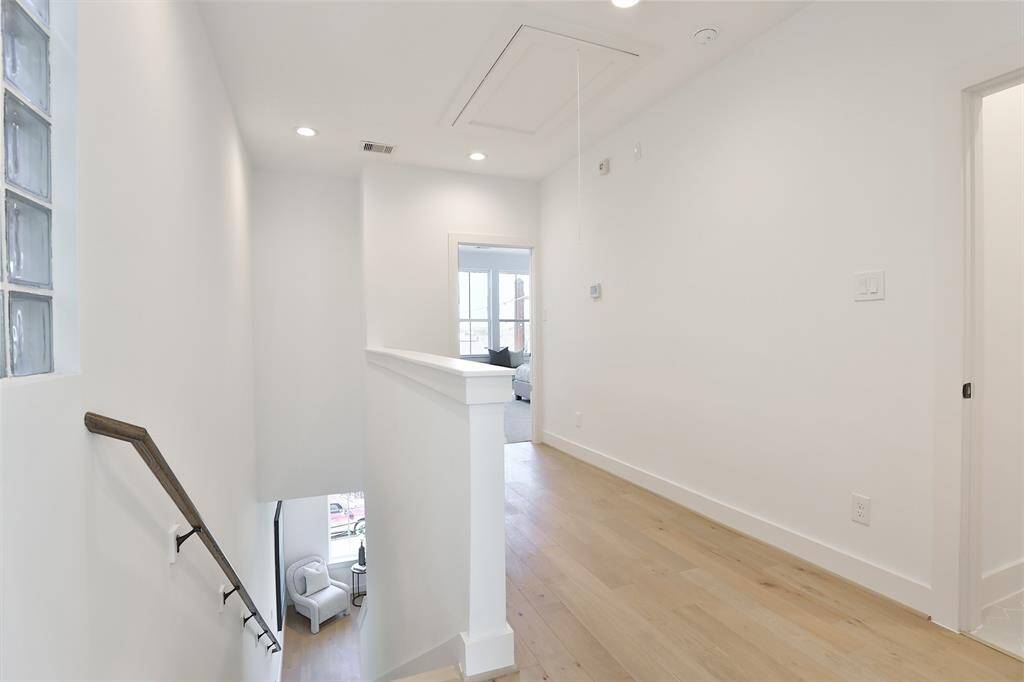 The third-floor landing leads to the luxurious primary suite. A conveniently located utility room on this level adds ease to everyday living.