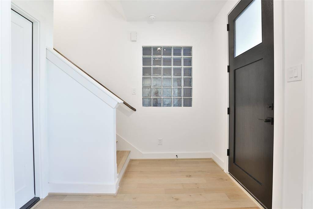 Step through the front door where stunning blonde wood floors create a warm and inviting atmosphere.